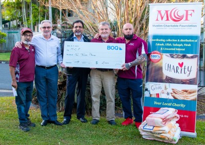 MCF volunteers receiving a donation from Bank of Queensland for blankets